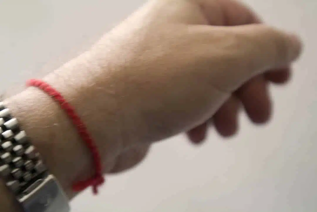 Femme méditant avec un bracelet rouge