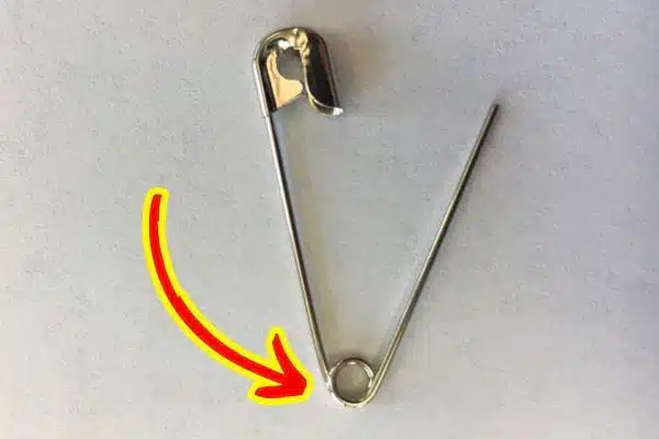 Épingles à nourrice métalliques alignées, mettant en évidence leur forme et leur trou